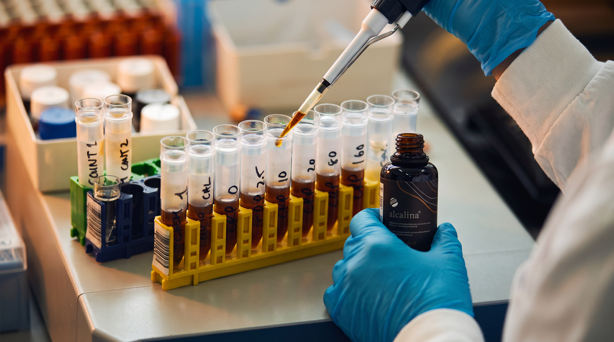 Laboratory vial containing a golden mineral solution.